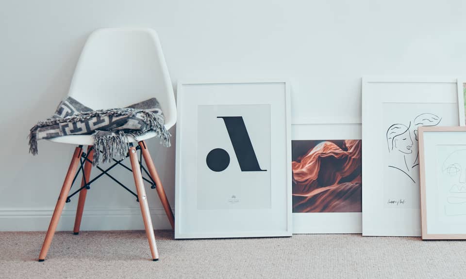 Photo of a chair and pictures in an interior.